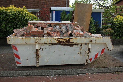 Construction site with builders waste being cleared in Hampstead